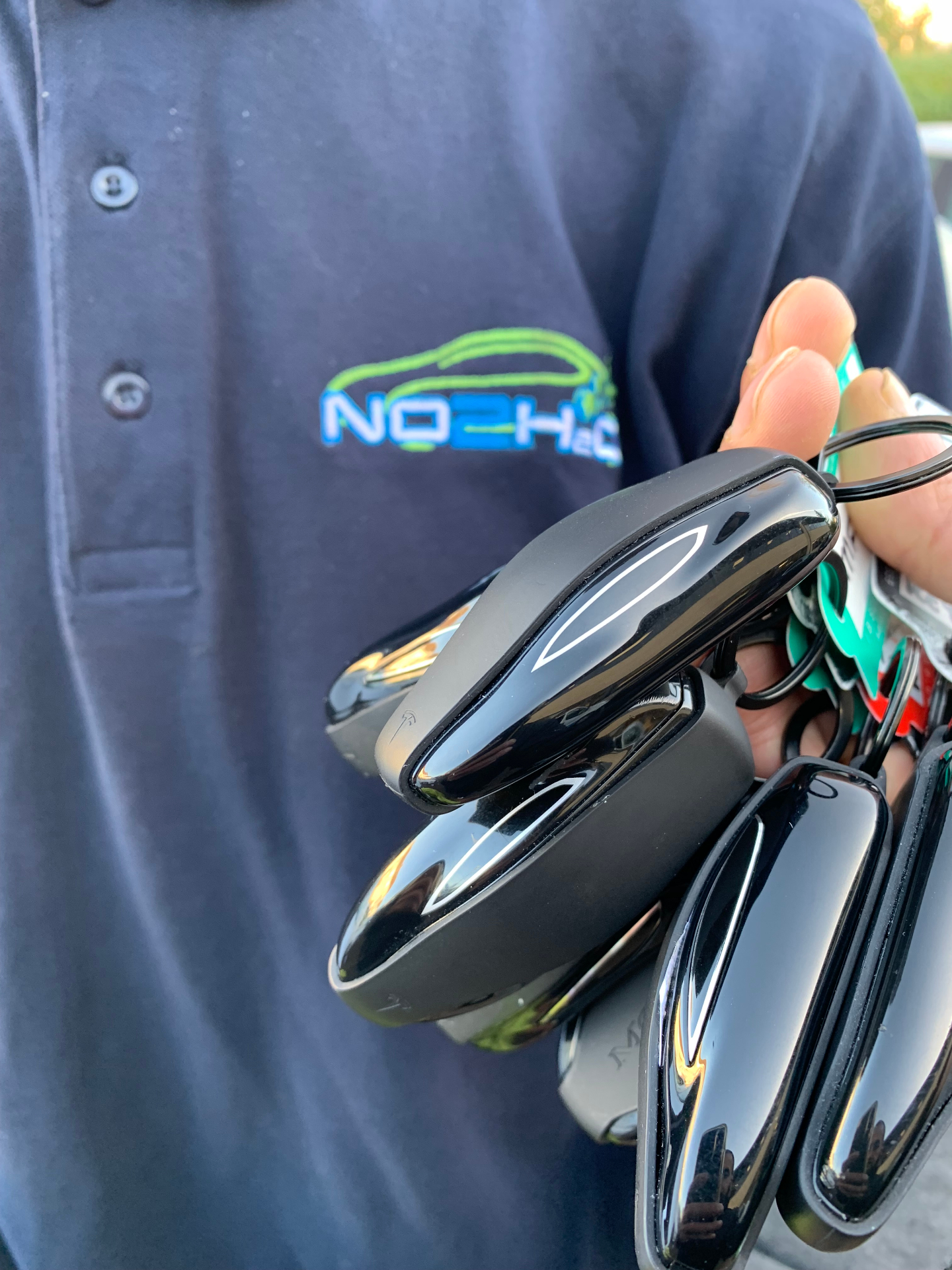 NO2H2O branded polo shirt with a handful of freshly detailed car keys