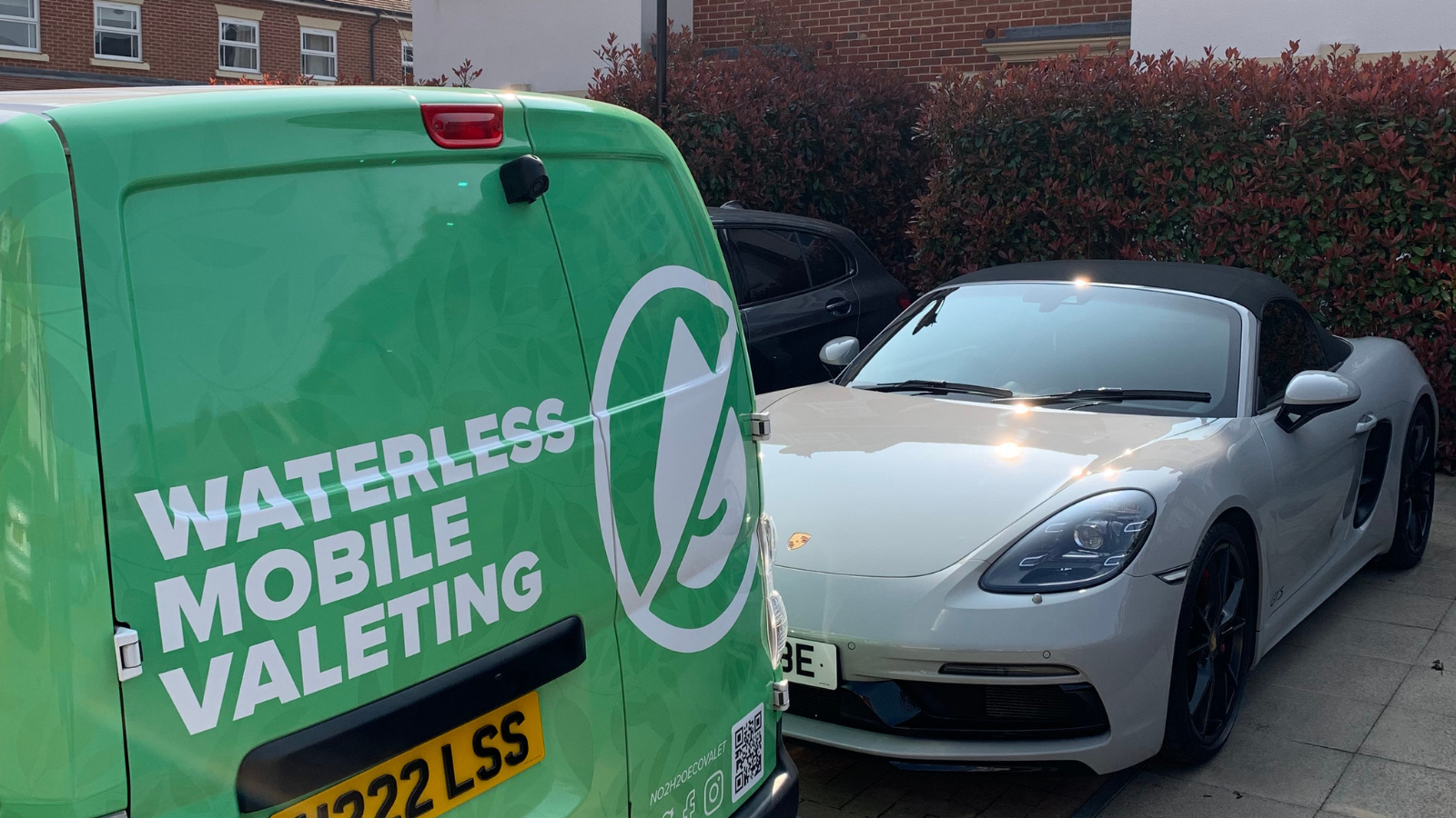 NO2H2O waterless mobile valeting van parked next to a white Porsche Boxster on a London driveway